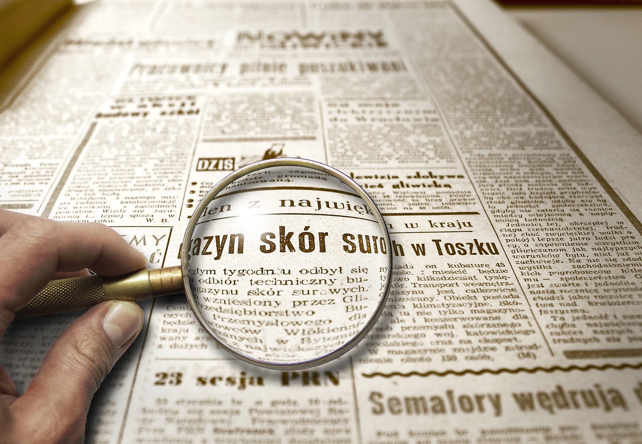 Magnifying Glass over Newspaper